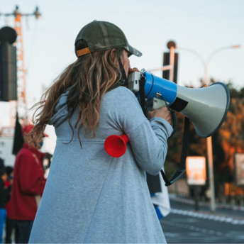 Person using megaphone during street protest