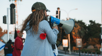 Person using megaphone during street protest