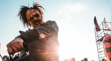 Performer in horror costume entertaining visitors at outdoor event