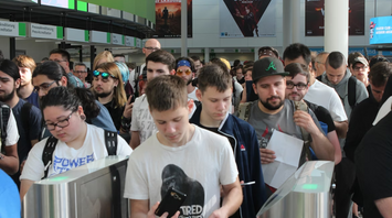 Passengers wait in long queues at airport check-in