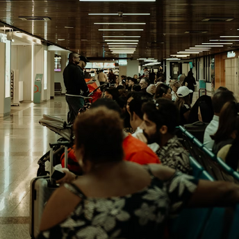 Passengers waiting in crowded airport seating area