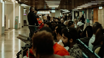 Passengers waiting in crowded airport seating area