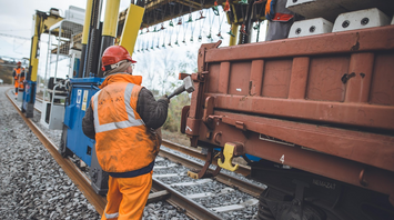 Rail worker performing track maintenance