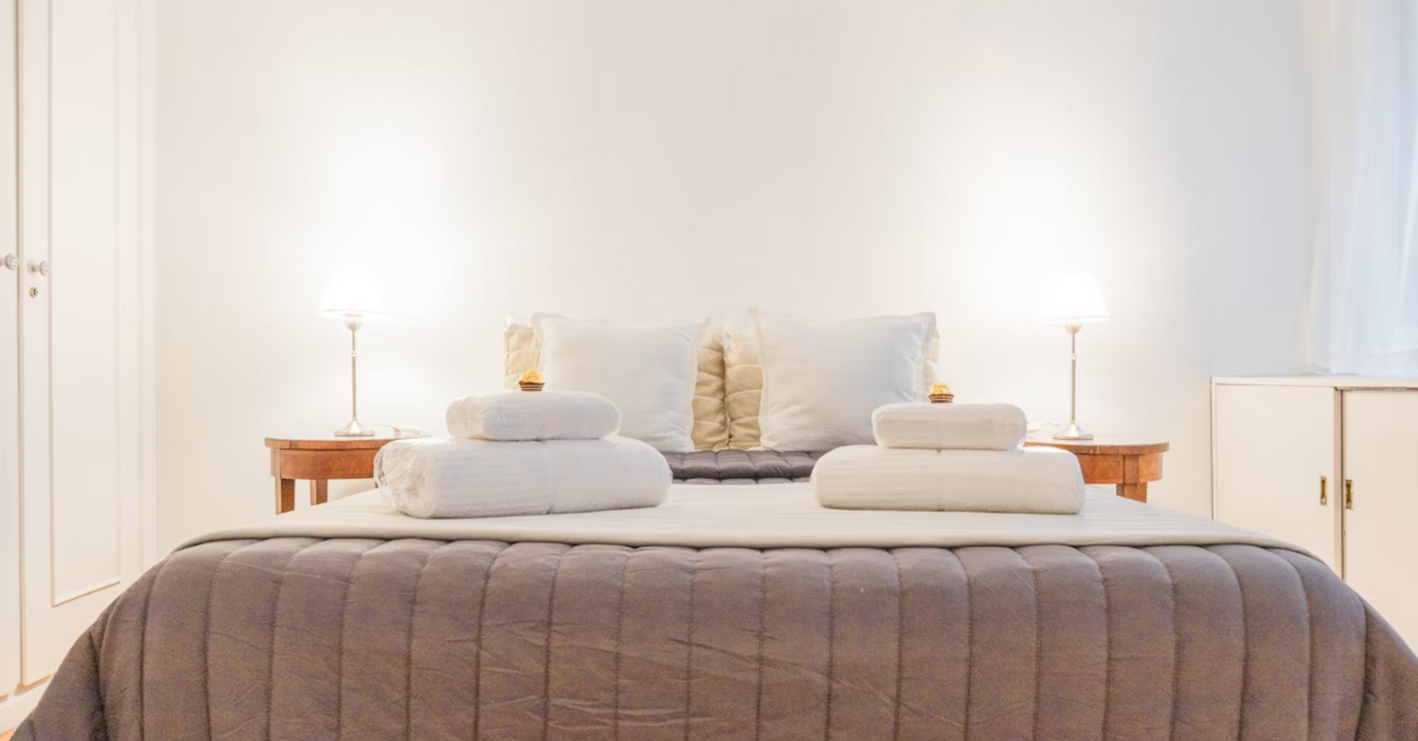 Modern hotel bedroom with fresh towels and soft lighting