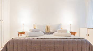 Modern hotel bedroom with fresh towels and soft lighting
