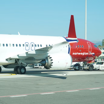 Norwegian airplane on tarmac at airport