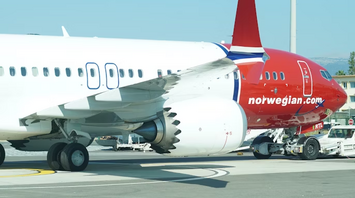 Norwegian airplane on tarmac at airport