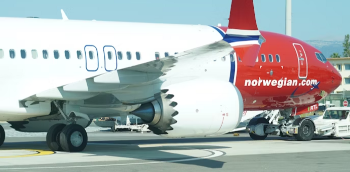 Norwegian airplane on tarmac at airport