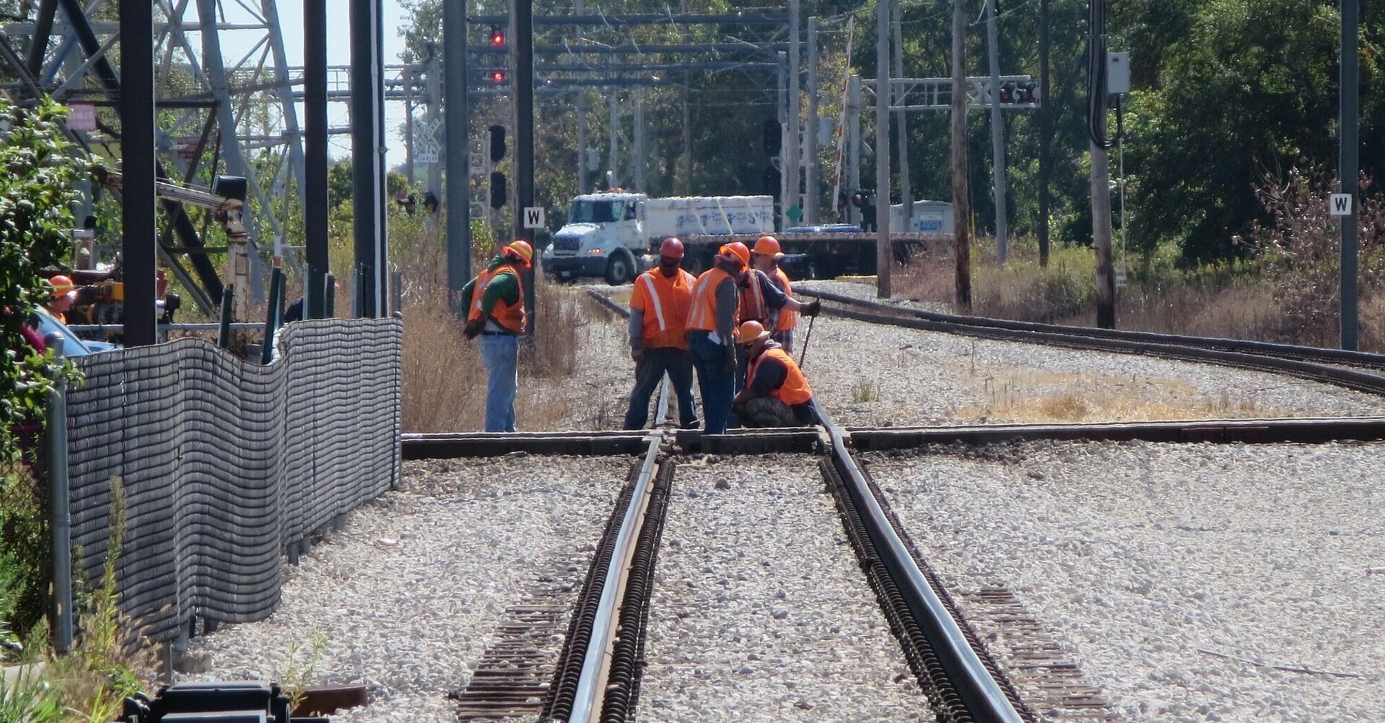 Workers carrying out railway maintenance on junction tracks