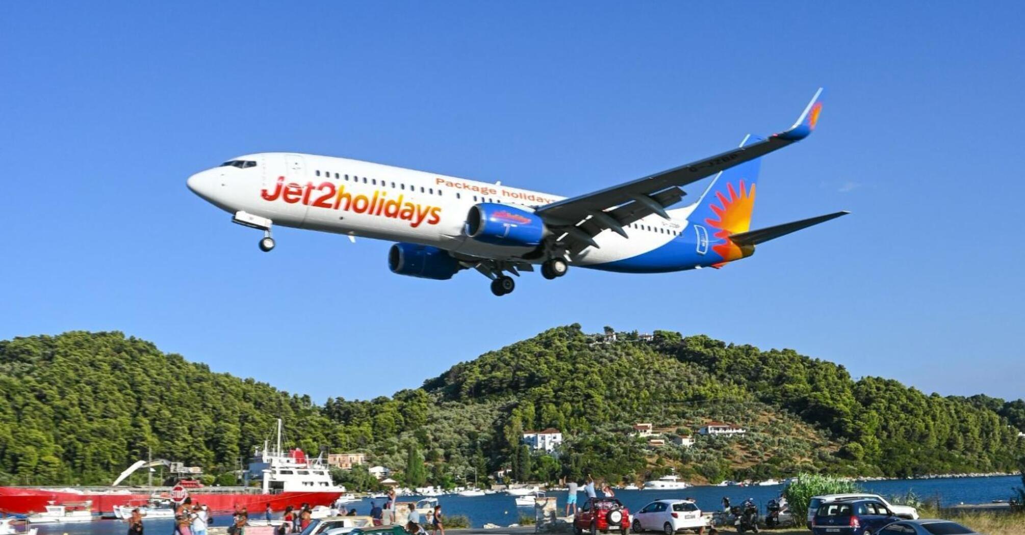 Jet2holidays plane landing over coastal road