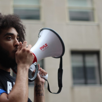 Person speaking through a megaphone during a strike