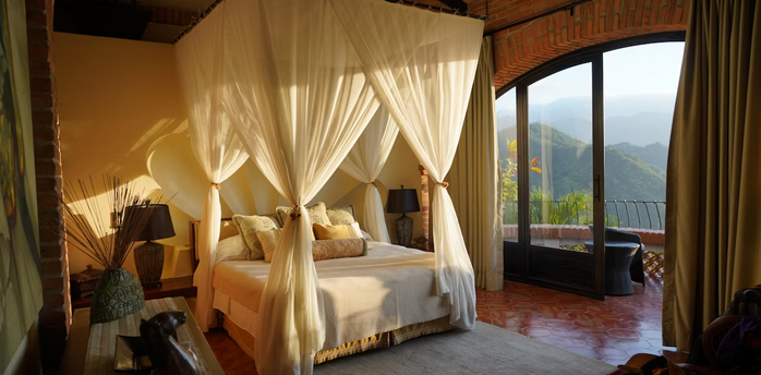Luxury bedroom with canopy bed and mountain view