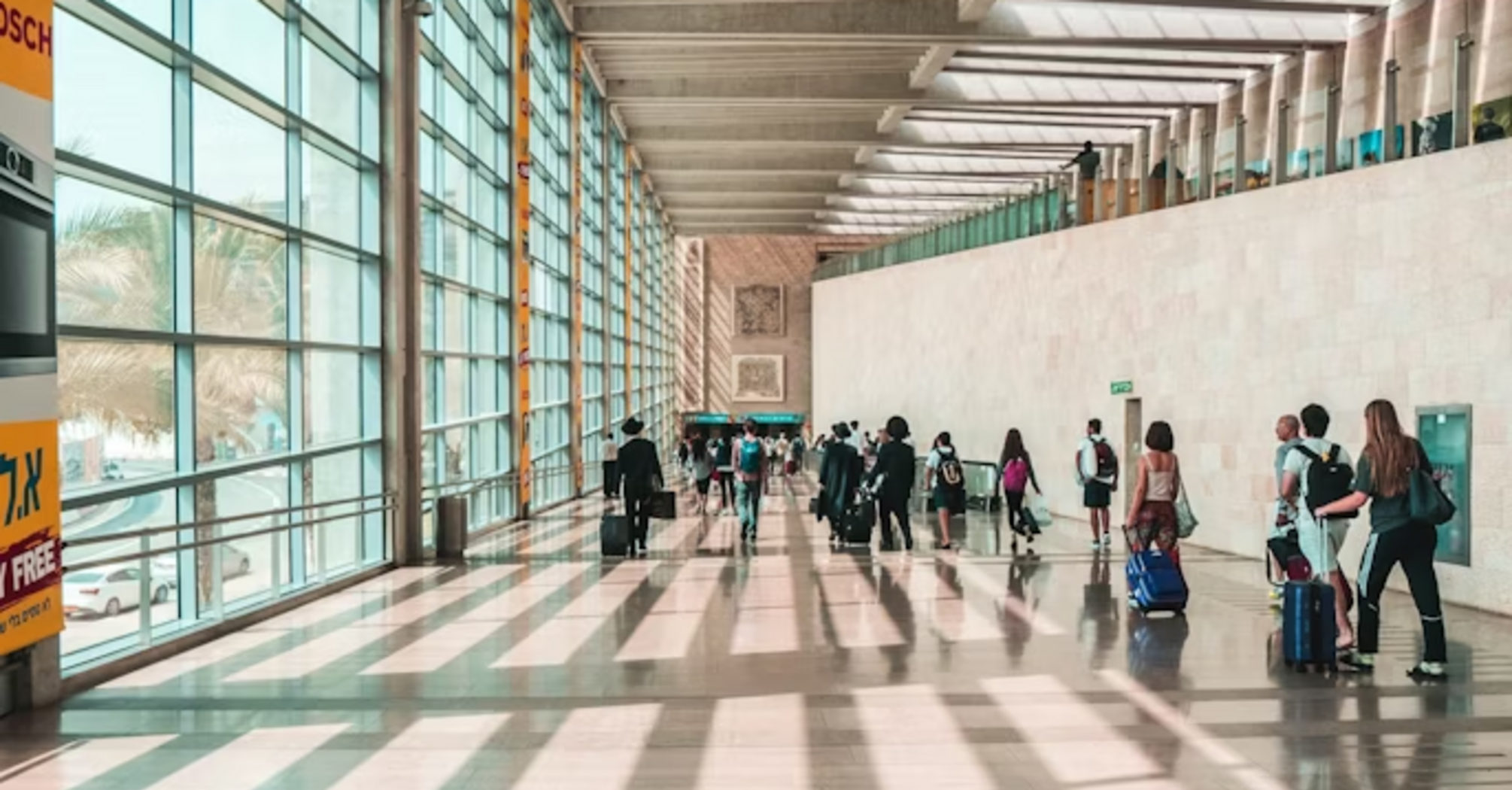 Passengers walking through Ben Gurion Airport terminal