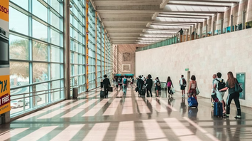 Passengers walking through Ben Gurion Airport terminal