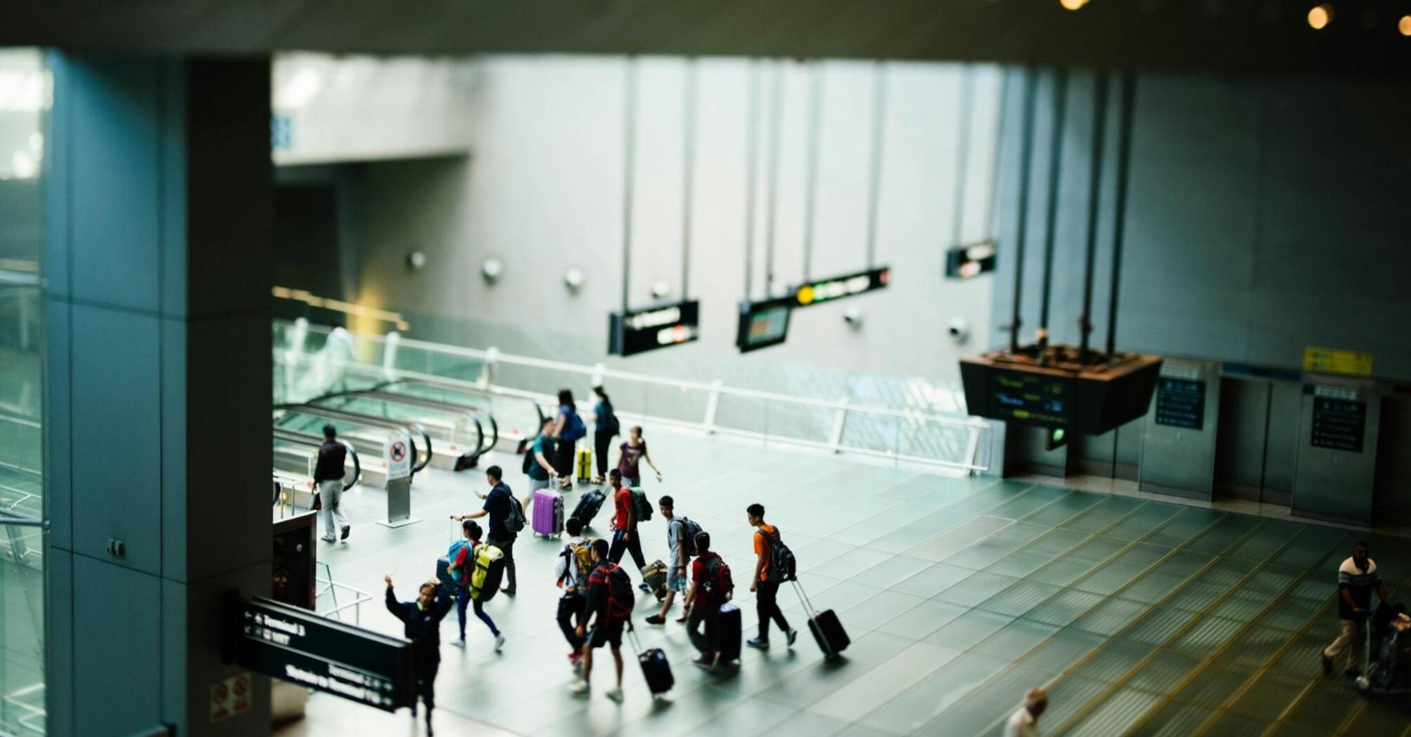 Passengers with luggage inside Stockholm Arlanda Airport terminal