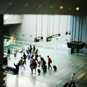 Passengers with luggage inside Stockholm Arlanda Airport terminal