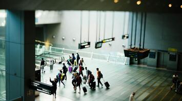 Passengers with luggage inside Stockholm Arlanda Airport terminal