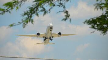 Passenger plane flying against blue sky