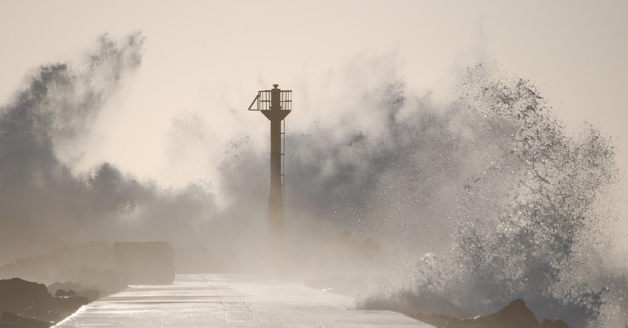 Storm waves crashing over coastal pier during Typhoon Tapah