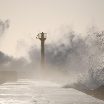 Storm waves crashing over coastal pier during Typhoon Tapah