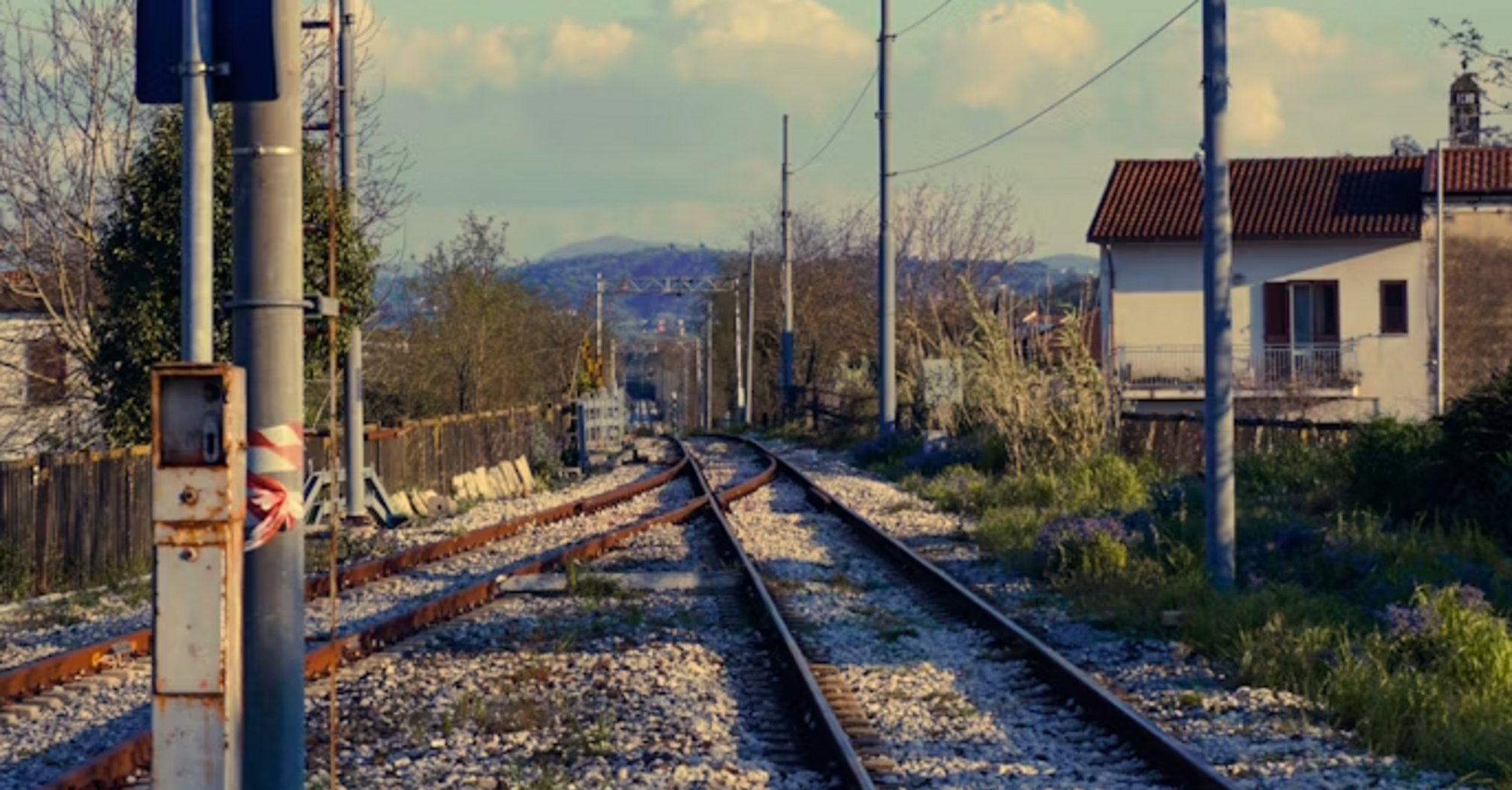 Railway signal on tracks with clear sky