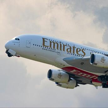 Emirates Airbus A380 taking off into cloudy sky
