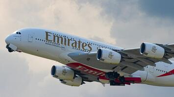 Emirates Airbus A380 taking off into cloudy sky