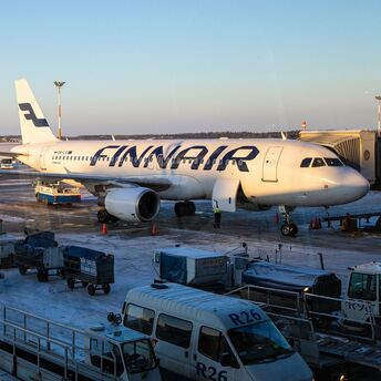 Finnair aircraft parked at snowy Helsinki Airport apron
