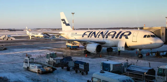 Finnair aircraft parked at snowy Helsinki Airport apron