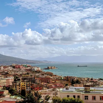 Panoramic view of Naples with Mount Vesuvius and the Gulf of Naples under a partly cloudy sky