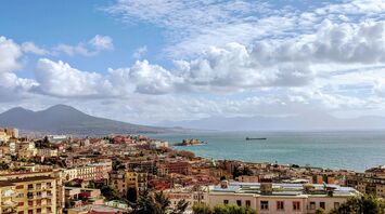 Panoramic view of Naples with Mount Vesuvius and the Gulf of Naples under a partly cloudy sky