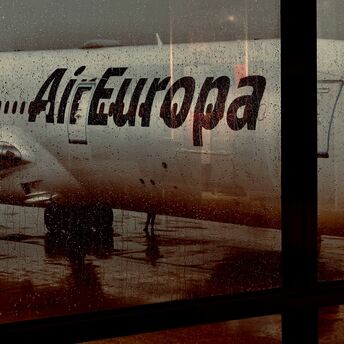 Air Europa aircraft seen through wet airport window