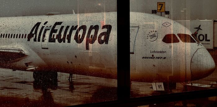 Air Europa aircraft seen through wet airport window