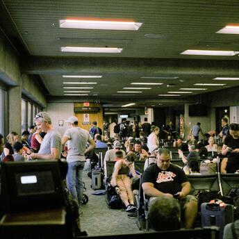 Passengers waiting in a crowded airport terminal