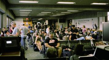 Passengers waiting in a crowded airport terminal