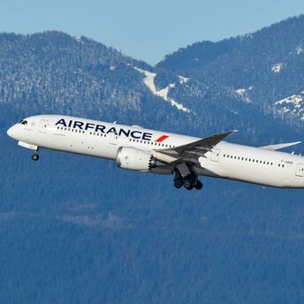 Air France aircraft taking off against mountain backdrop
