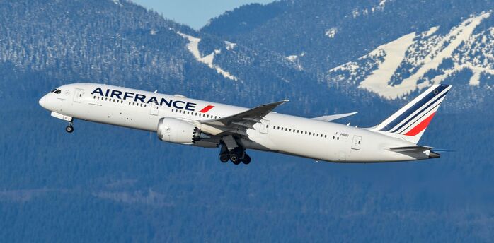 Air France aircraft taking off against mountain backdrop