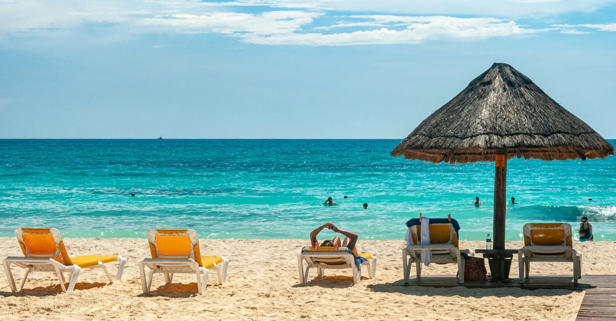 Sun loungers and parasol on a tropical beach