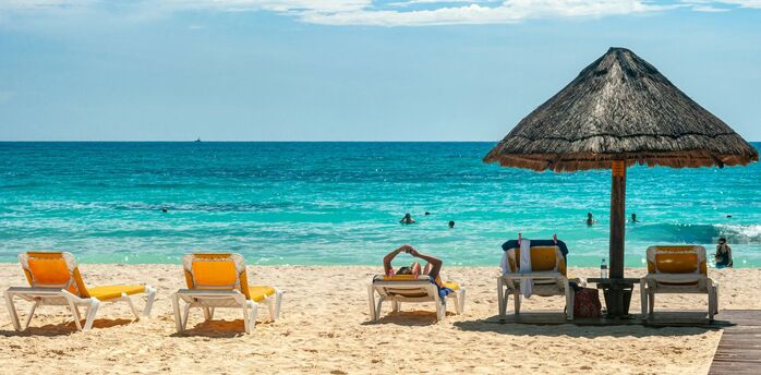 Sun loungers and parasol on a tropical beach