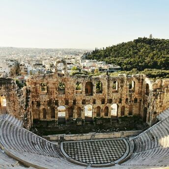 Ancient stone theatre overlooking Athens rooftops and hills