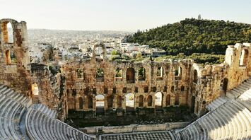 Ancient stone theatre overlooking Athens rooftops and hills
