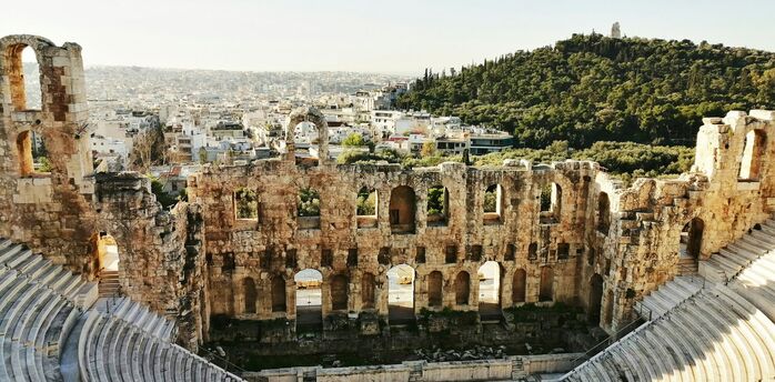 Ancient stone theatre overlooking Athens rooftops and hills