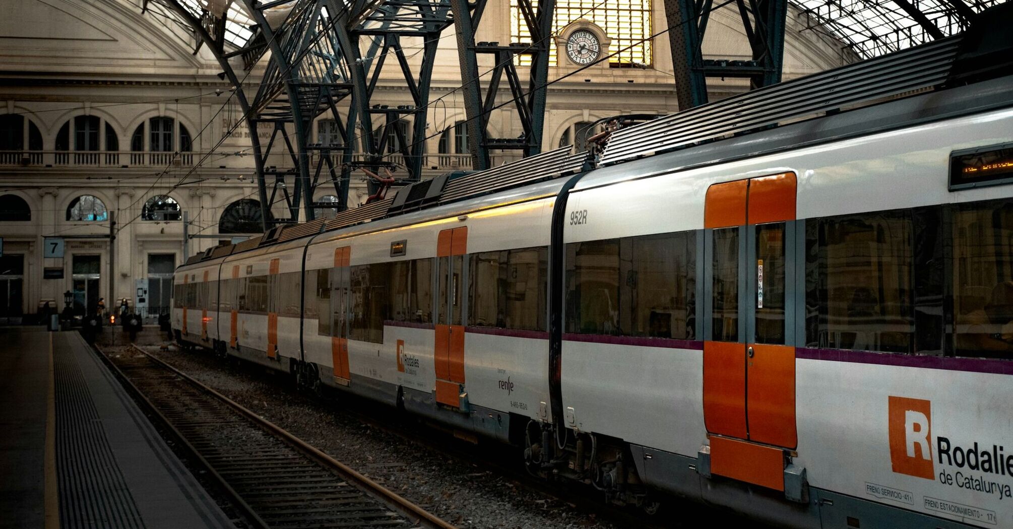 Renfe train at a Spanish station under iron roof