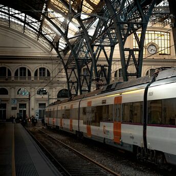 Renfe train at a Spanish station under iron roof