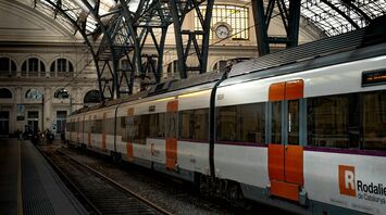 Renfe train at a Spanish station under iron roof