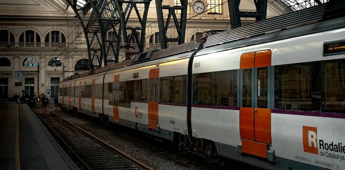 Renfe train at a Spanish station under iron roof