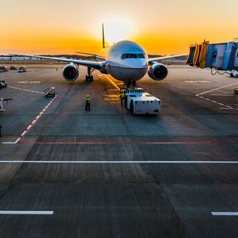Airliner at a remote airport stand at sunset