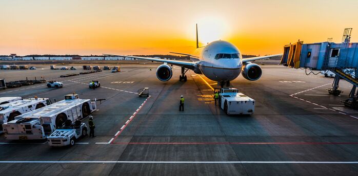 Airliner at a remote airport stand at sunset