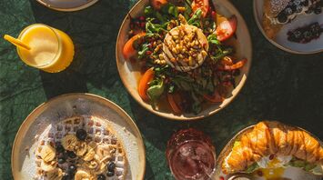 Colourful breakfast and brunch dishes on a table with natural sunlight