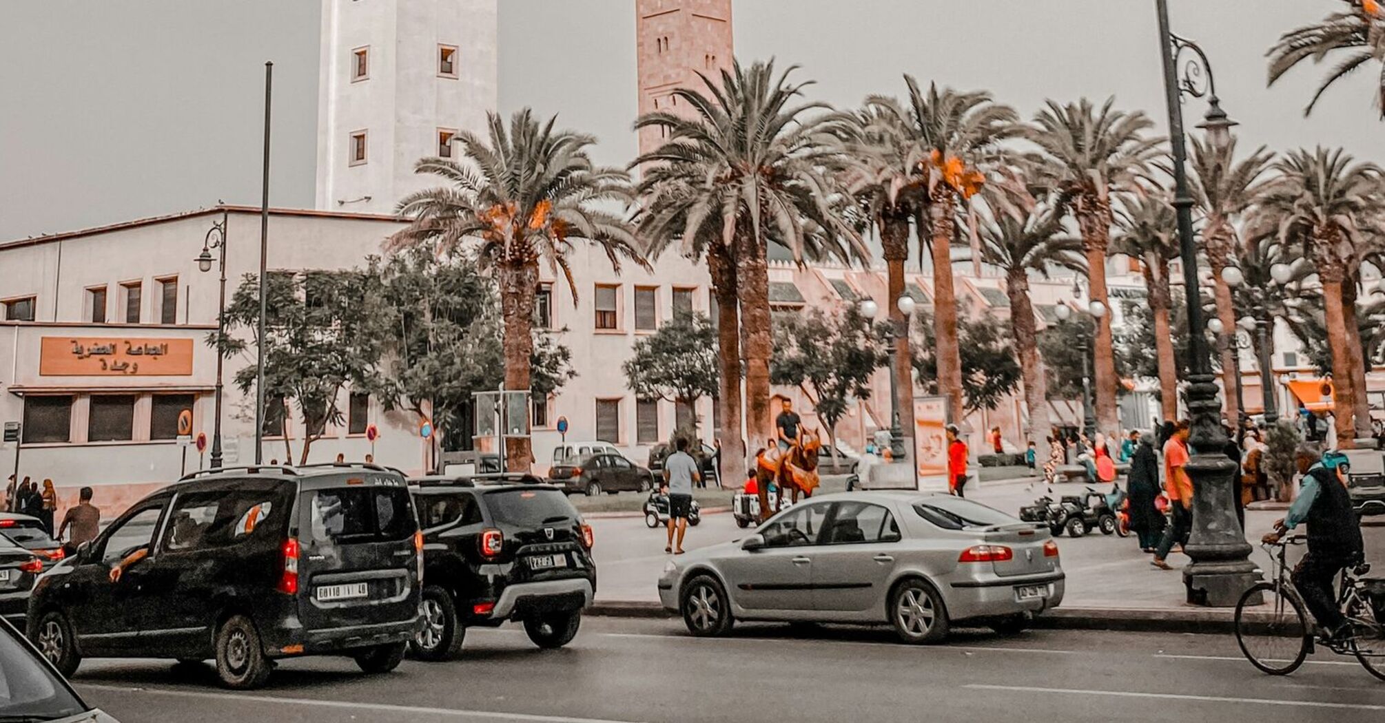 Street view with Oujda’s clock tower and busy city traffic